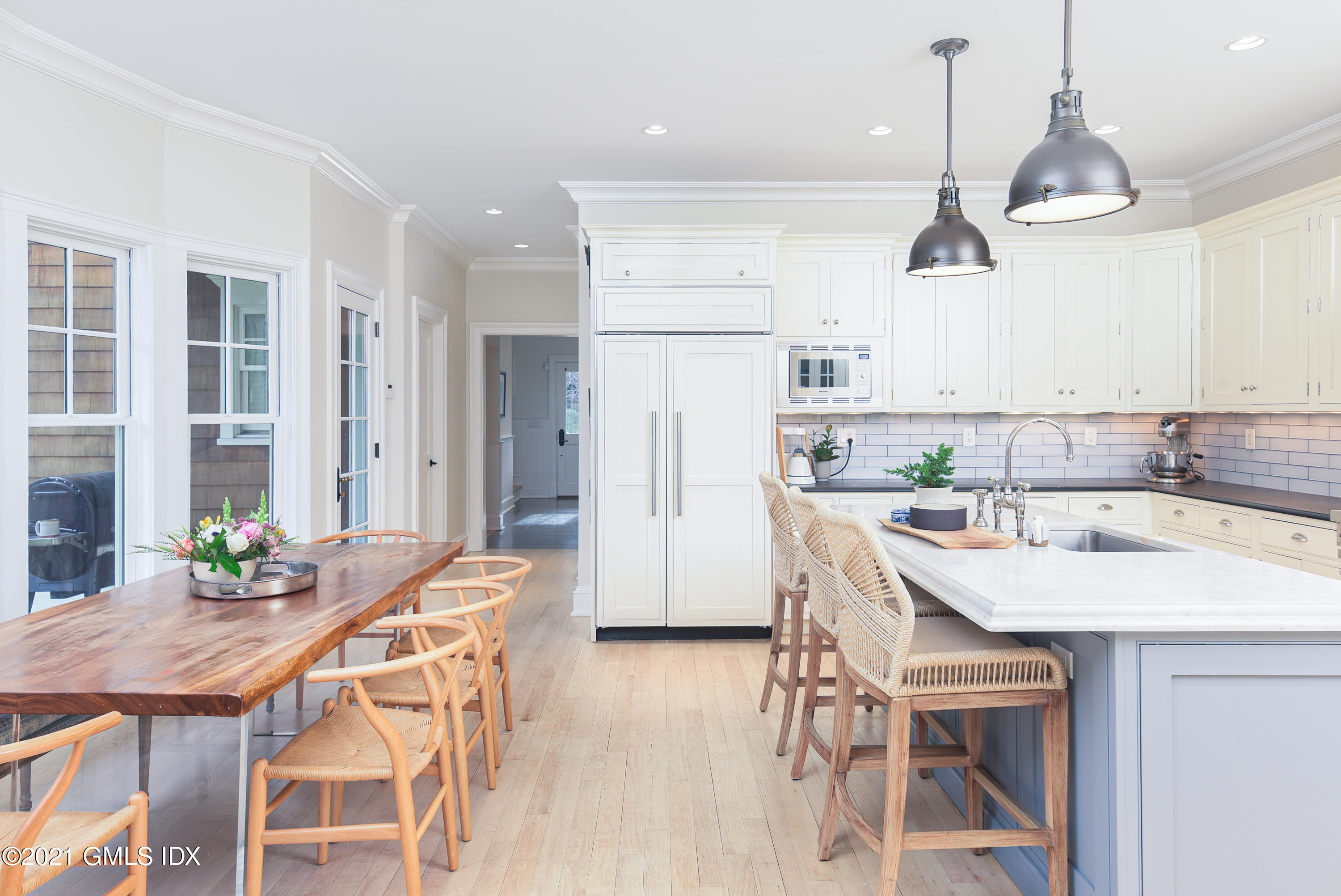 44 Glen Avon Drive Riverside, CT 06878 - Photo 16 of 39 a kitchen with stainless steel appliances kitchen island granite countertop a dining table chairs and white cabinets