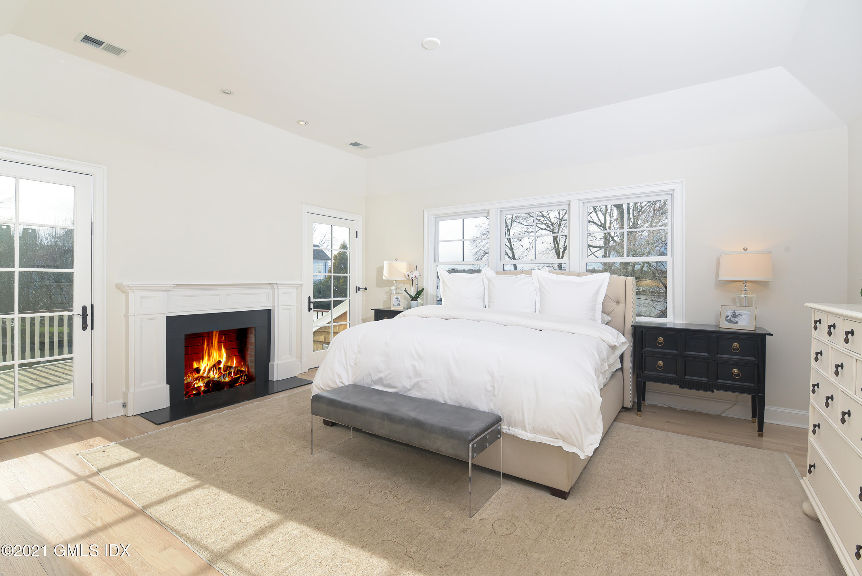 44 Glen Avon Drive Riverside, CT 06878 - Photo 18 of 39 a spacious bedroom with a bed and a fireplace