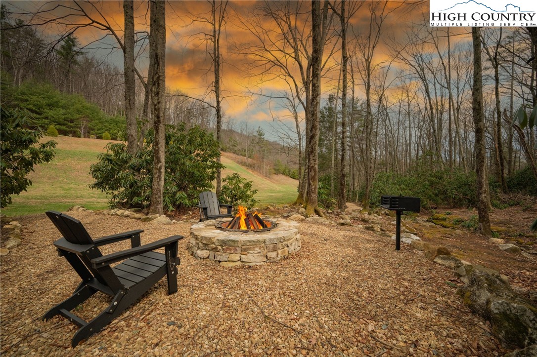 Lot 150 Angel Fire Trail Dobson, NC 27017 - Photo 21 of 27 a view of a lake with chairs and wooden fence