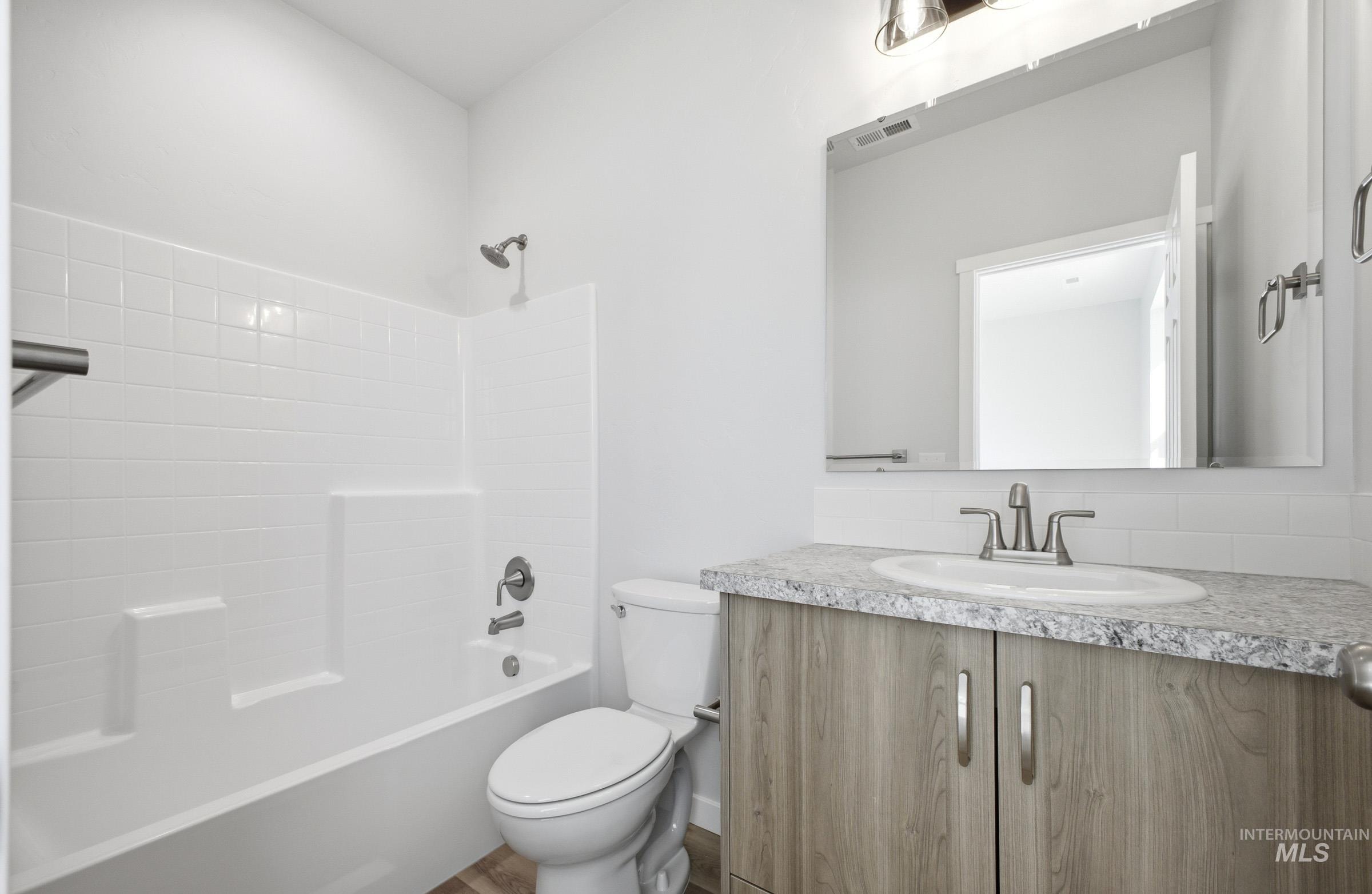13633 Redway Court Caldwell, ID 83607 - Photo 21 of 29 Full bathroom featuring vanity, bathing tub / shower combination, and decorative backsplash