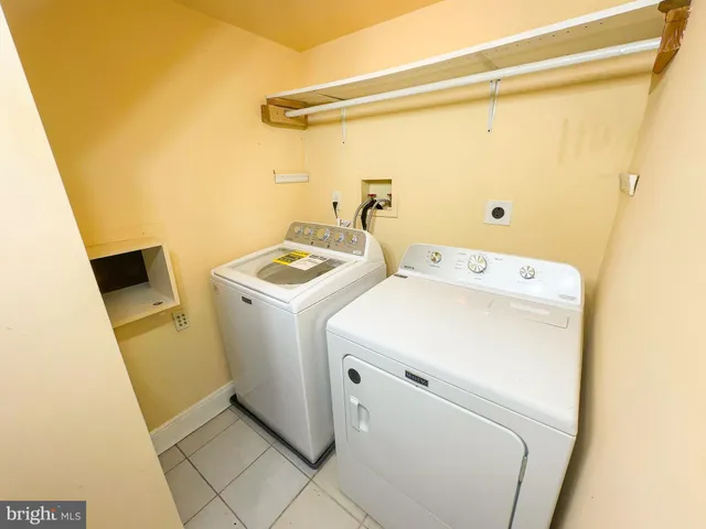 an empty room with a window and a ceiling fan