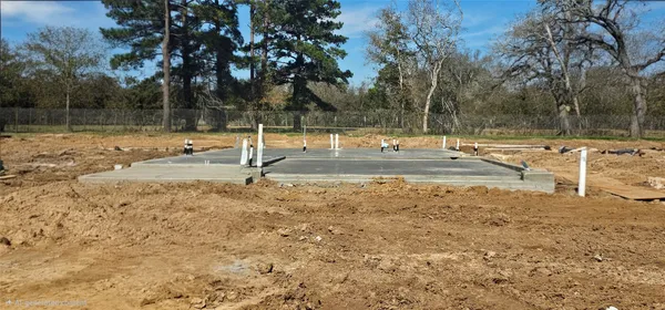 a view of a yard with wooden fence