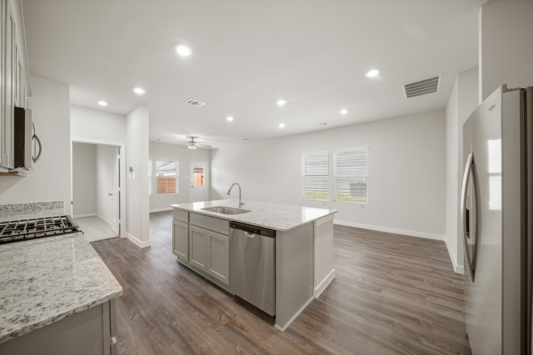 233 Spring Drive Hockley, TX 77447 - Photo 7 of 24 a kitchen with stainless steel appliances granite countertop a stove and a refrigerator