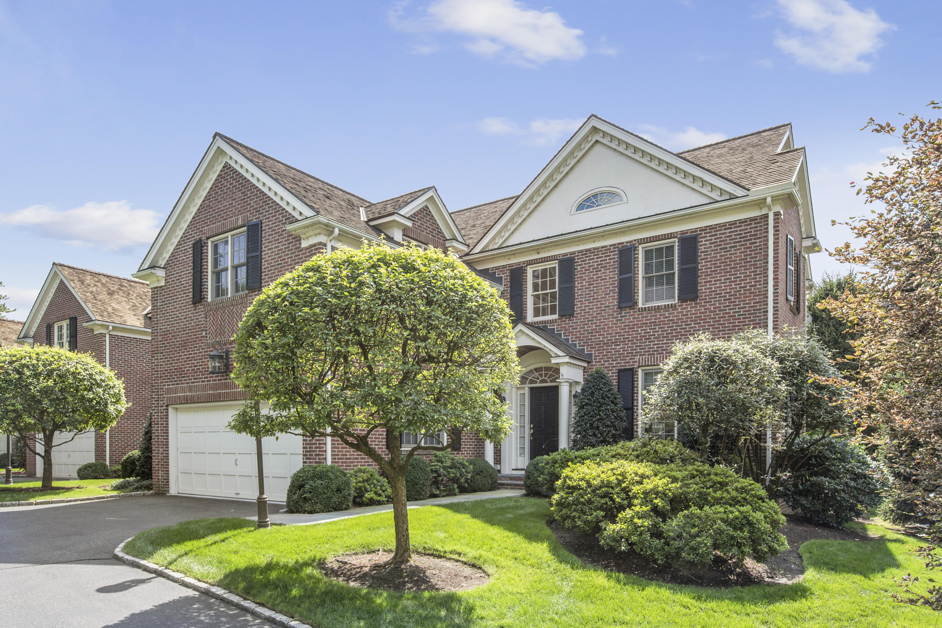 30 Richmond Hill Road, Unit 4 New Canaan, CT 06840 - Photo 1 of 40 a front view of a house with garden