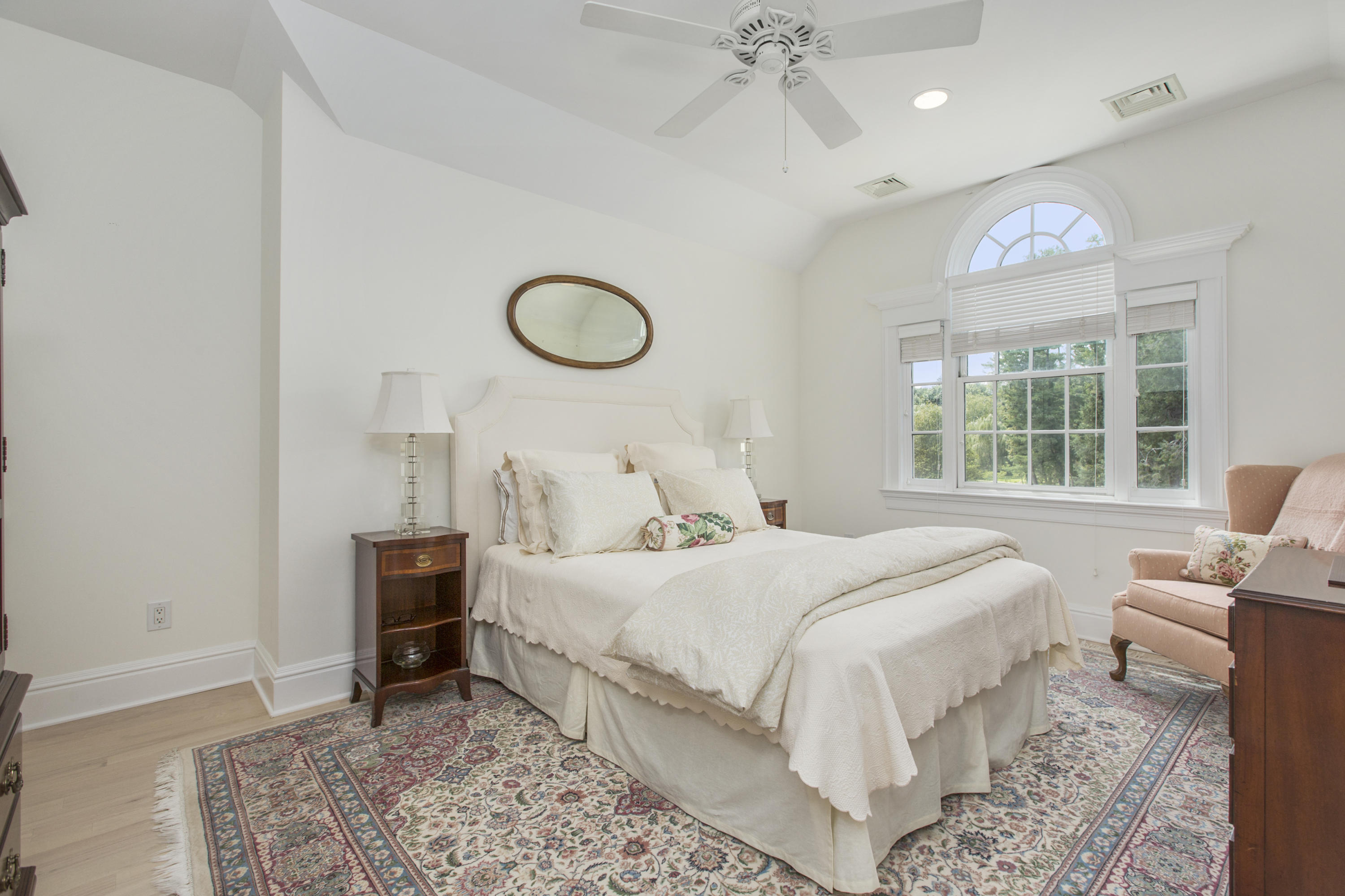 30 Richmond Hill Road, Unit 4 New Canaan, CT 06840 - Photo 27 of 40 a bedroom with a bed and a chandelier