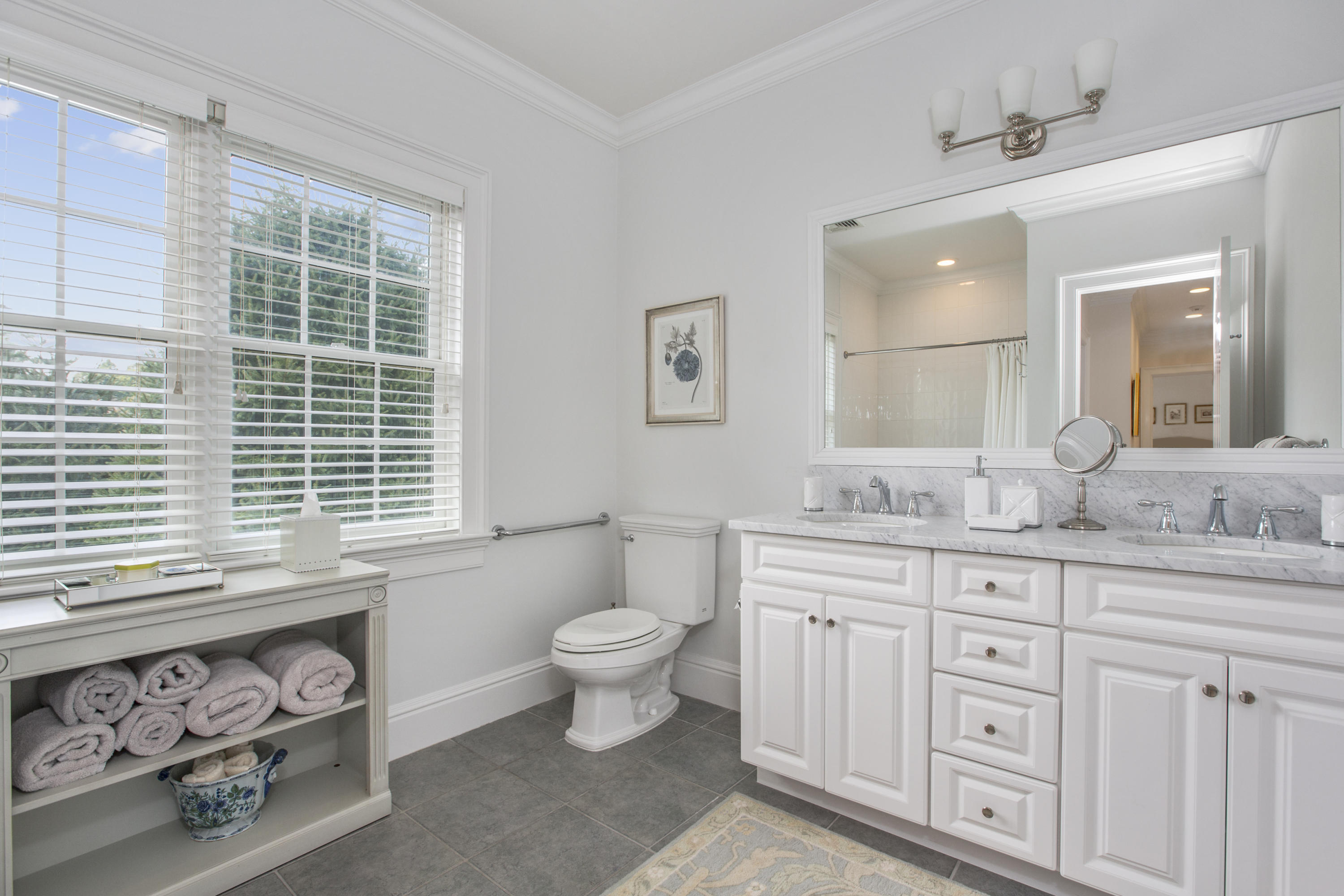30 Richmond Hill Road, Unit 4 New Canaan, CT 06840 - Photo 28 of 40 a bathroom with a granite countertop toilet a sink a mirror and a window