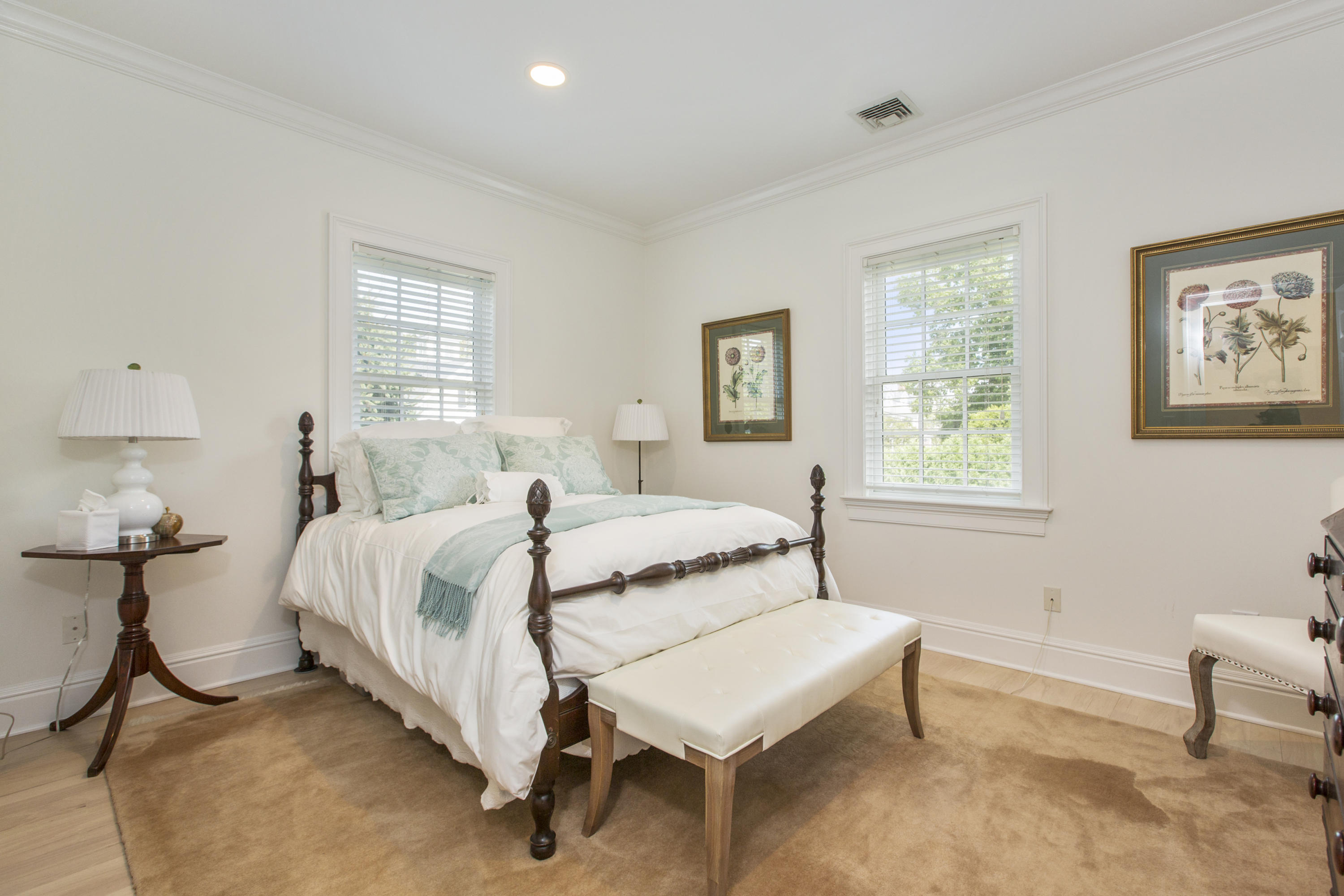 30 Richmond Hill Road, Unit 4 New Canaan, CT 06840 - Photo 29 of 40 a bedroom with a bed and a table in it with window