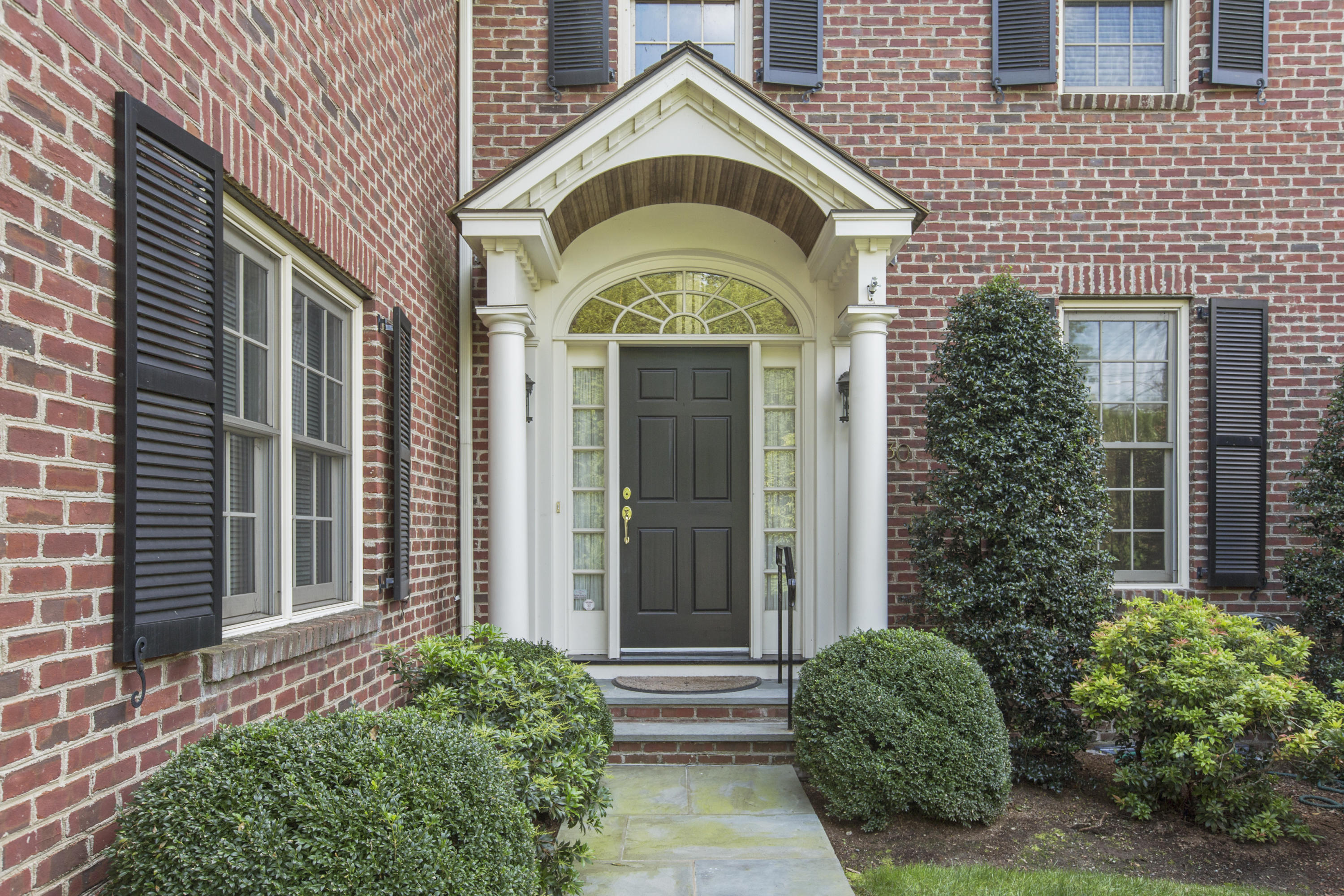 30 Richmond Hill Road, Unit 4 New Canaan, CT 06840 - Photo 4 of 40 a view of a brick house with large windows