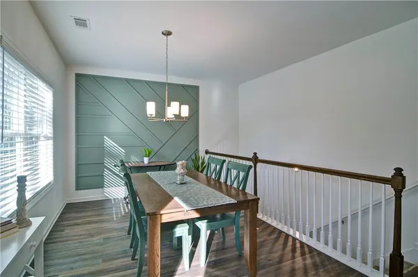 a view of a dining room with furniture window and wooden floor