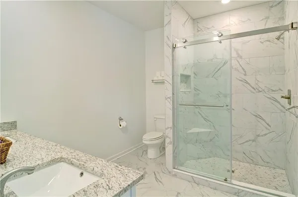 a bathroom with a sink toilet and shower