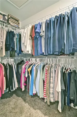a view of walk in closet with clothes