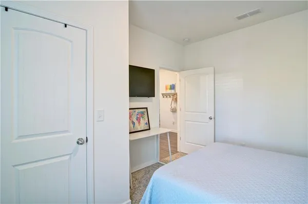 a bedroom with a bed and a flat screen tv