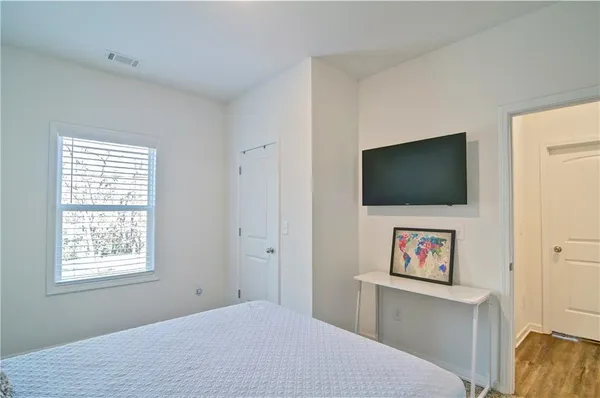 a bed room with a bed and a flat screen tv