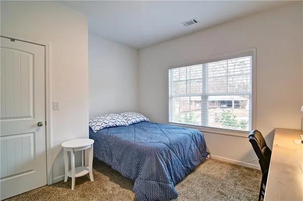 a bedroom with a bed and a window