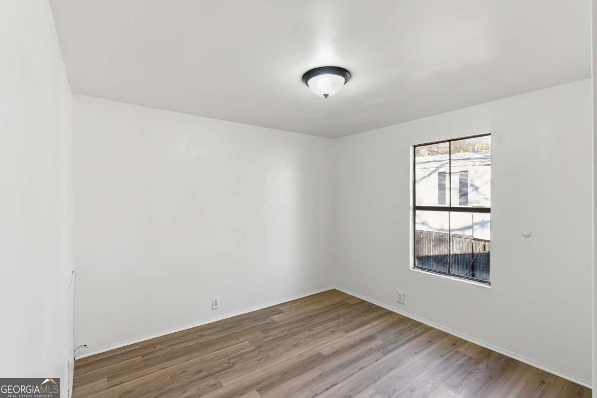 129 Rising Fawn Trail Northeast Rome, GA 30165 - Photo 18 of 25 an empty room with wooden floor and windows