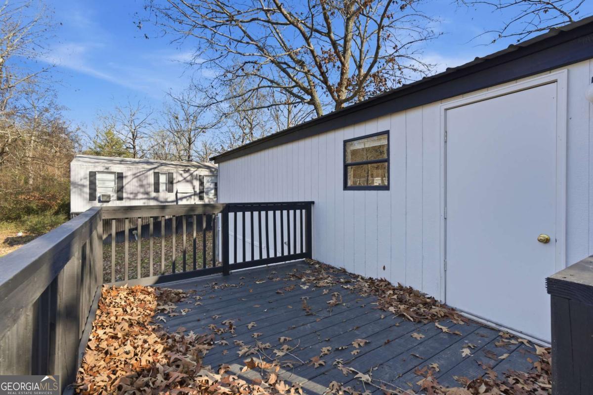 129 Rising Fawn Trail Northeast Rome, GA 30165 - Photo 20 of 25 a view of a porch with wooden floor and fence
