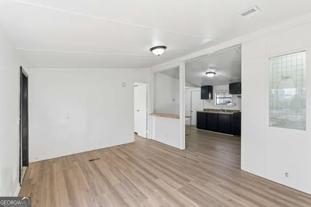 a view of a kitchen and kitchen island wooden floor