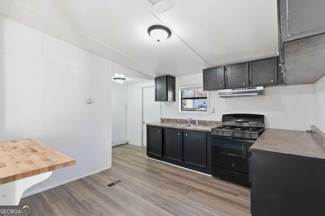 a kitchen with stainless steel appliances granite countertop a stove and a sink