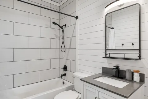 a bathroom with a bathtub and shower