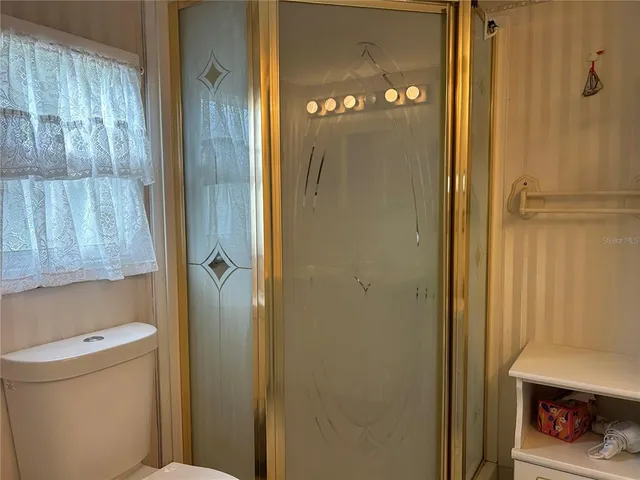 a bathroom with a shower and a toilet