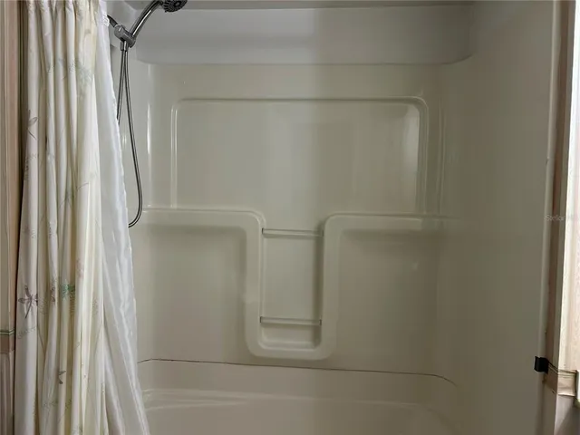 a bathroom with a glass shower door