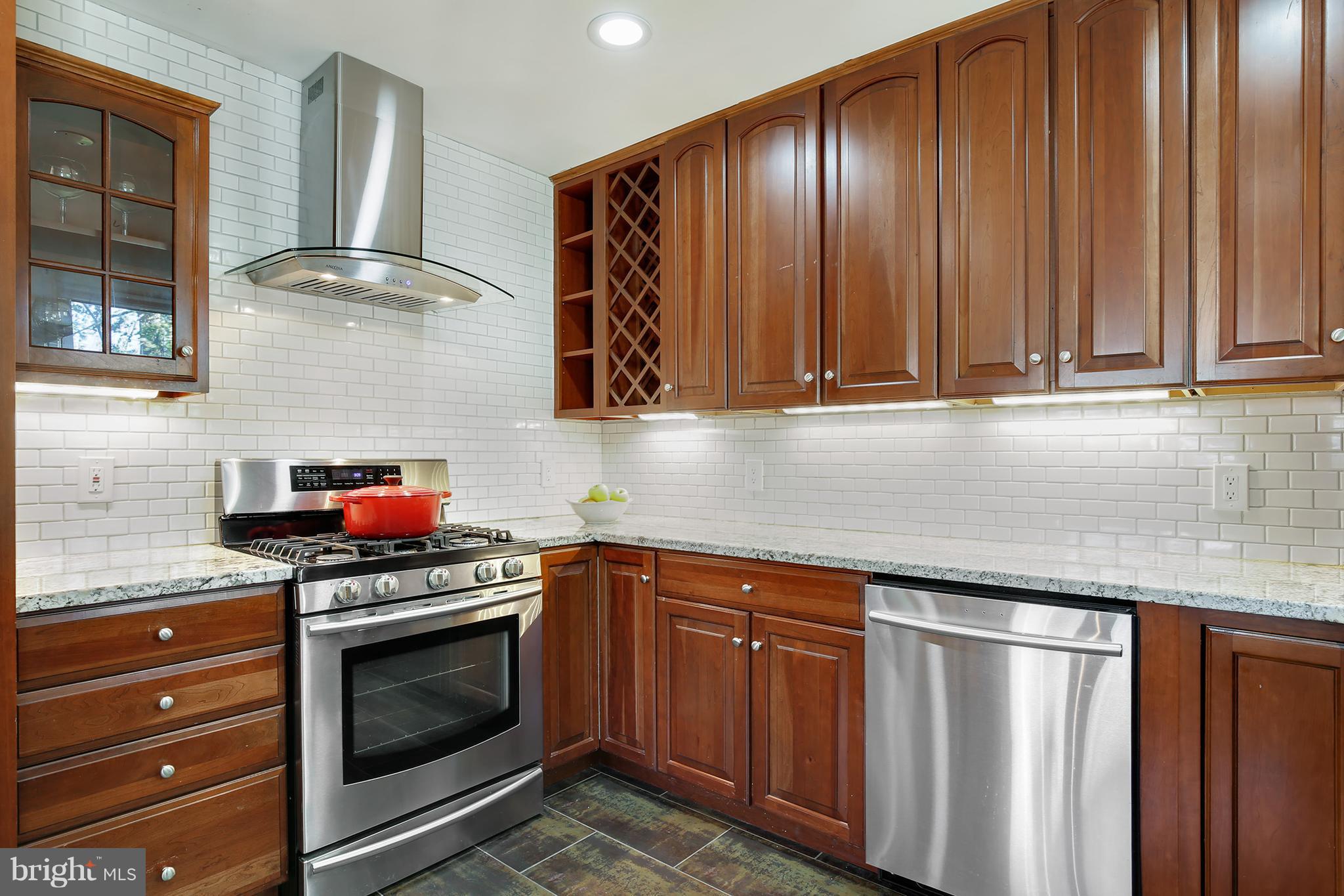 7422 Dunston Street Springfield, VA 22151 - Photo 12 of 30 a kitchen with granite countertop stainless steel appliances a stove a sink and dishwasher