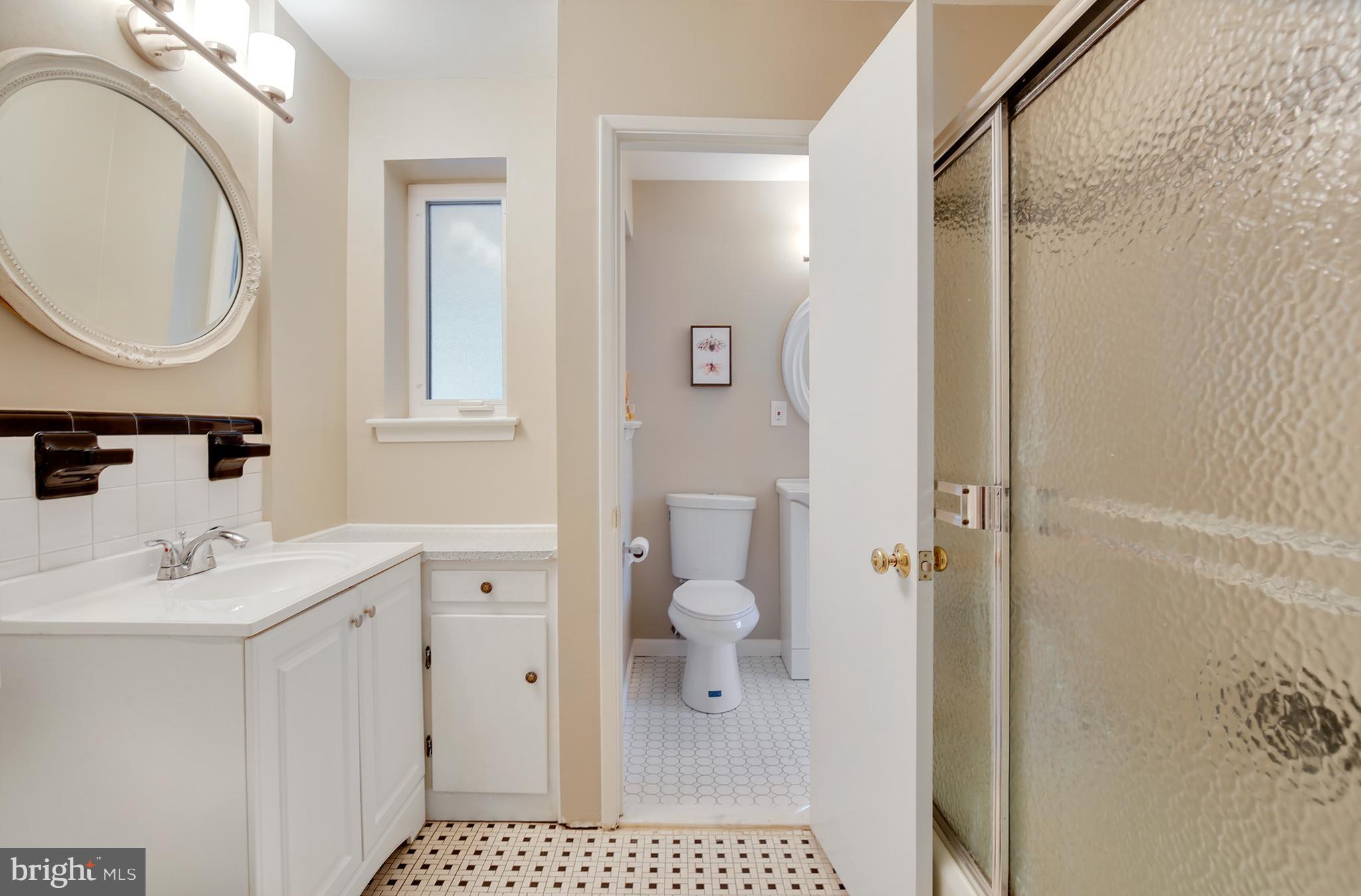 7422 Dunston Street Springfield, VA 22151 - Photo 15 of 30 a bathroom with a sink a toilet and a mirror