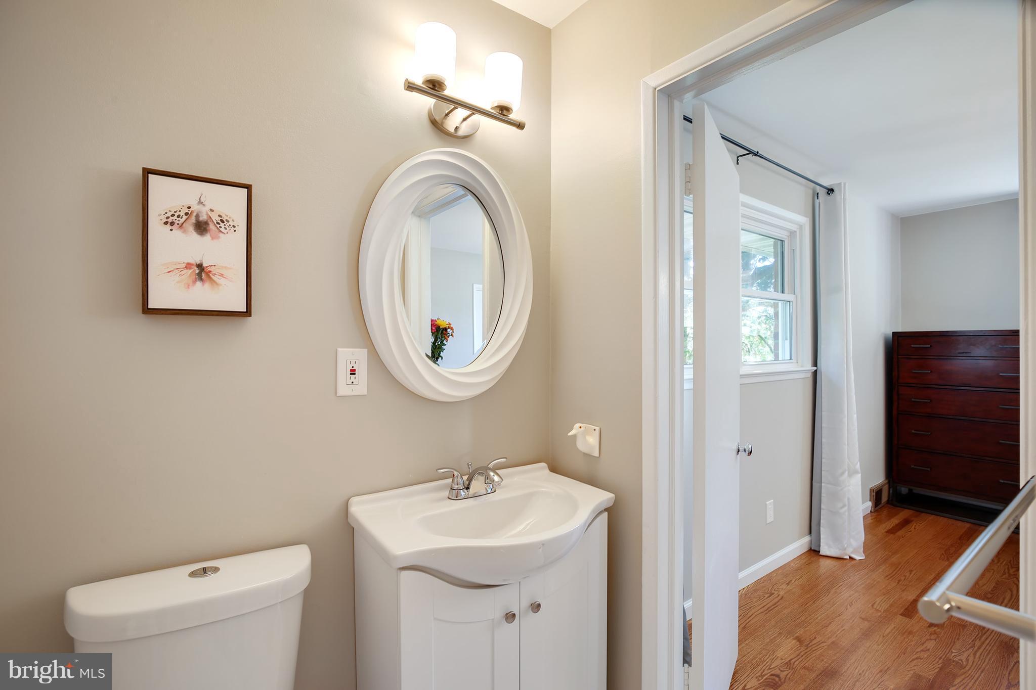 7422 Dunston Street Springfield, VA 22151 - Photo 16 of 30 a bathroom with a toilet sink and mirror