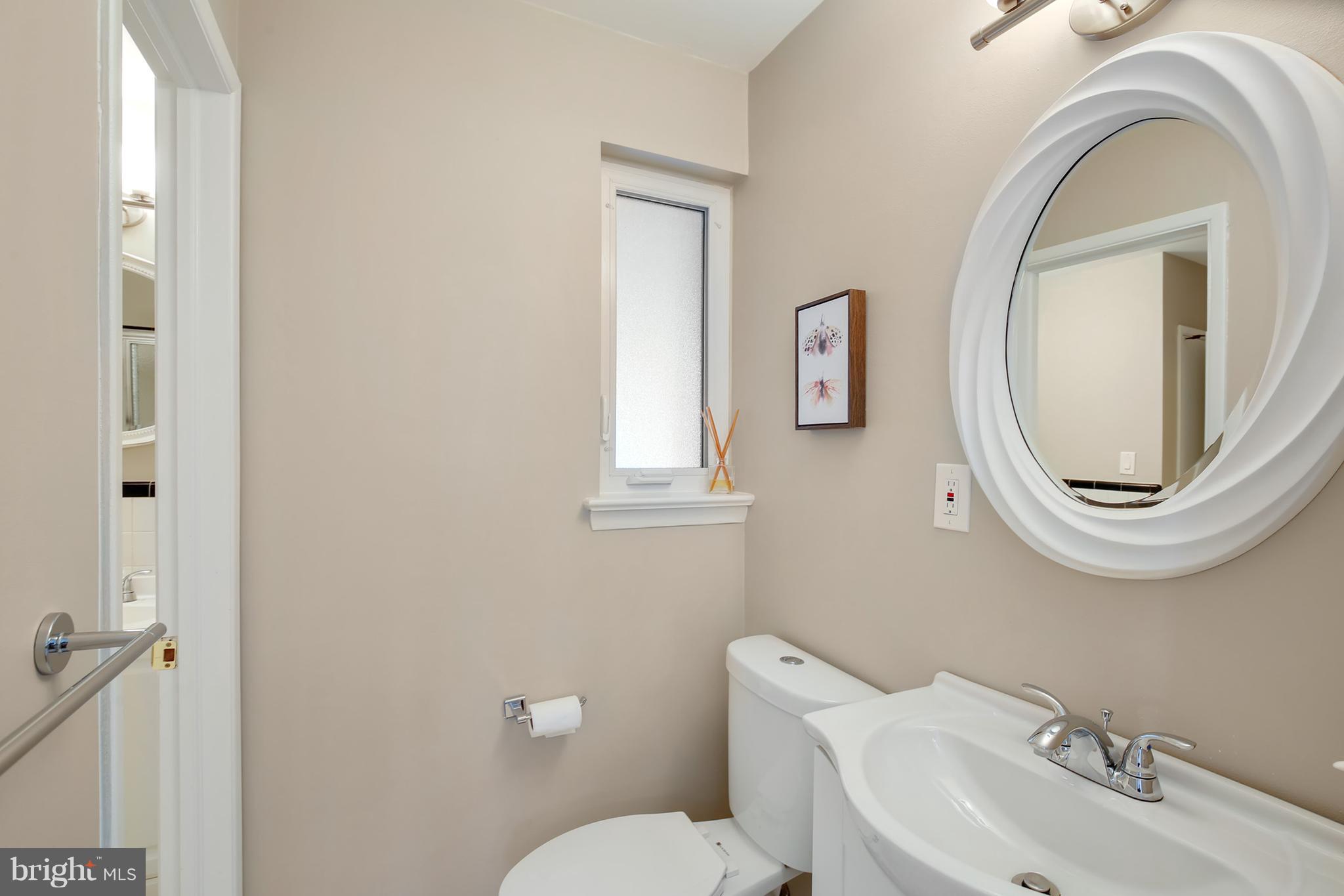 7422 Dunston Street Springfield, VA 22151 - Photo 17 of 30 a bathroom with a toilet a sink and mirror