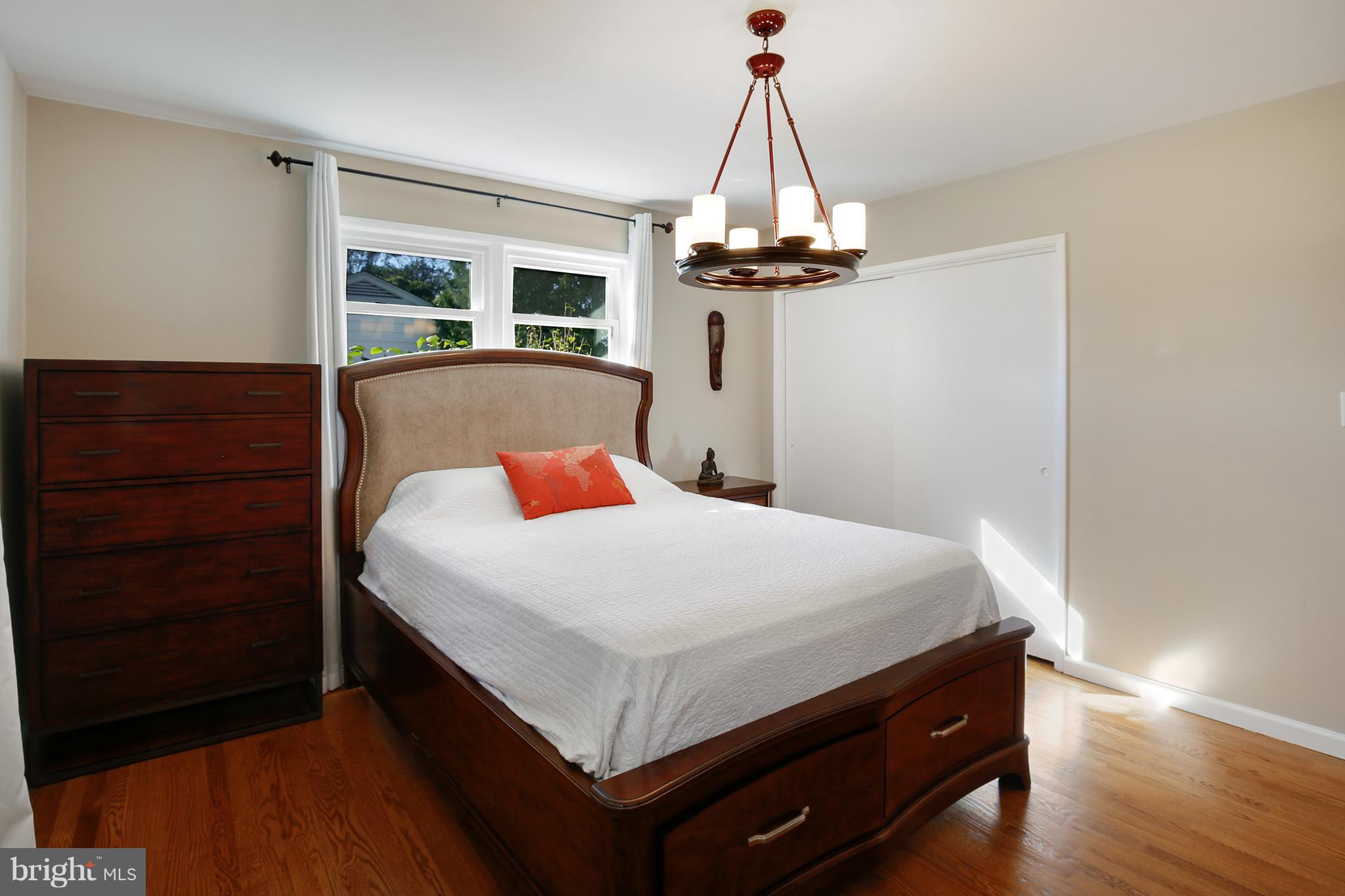 7422 Dunston Street Springfield, VA 22151 - Photo 18 of 30 a bed room with a bed and a dresser