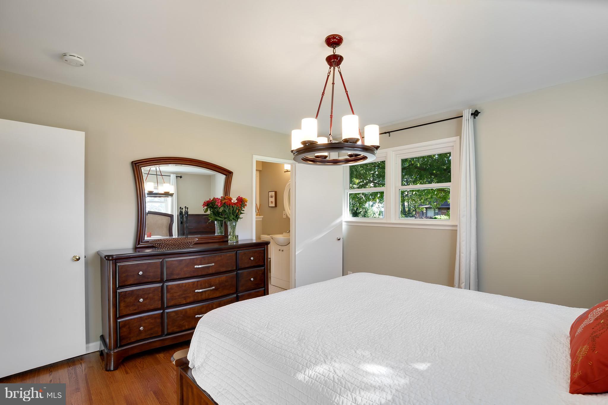 7422 Dunston Street Springfield, VA 22151 - Photo 19 of 30 a bedroom with a bed and a dresser