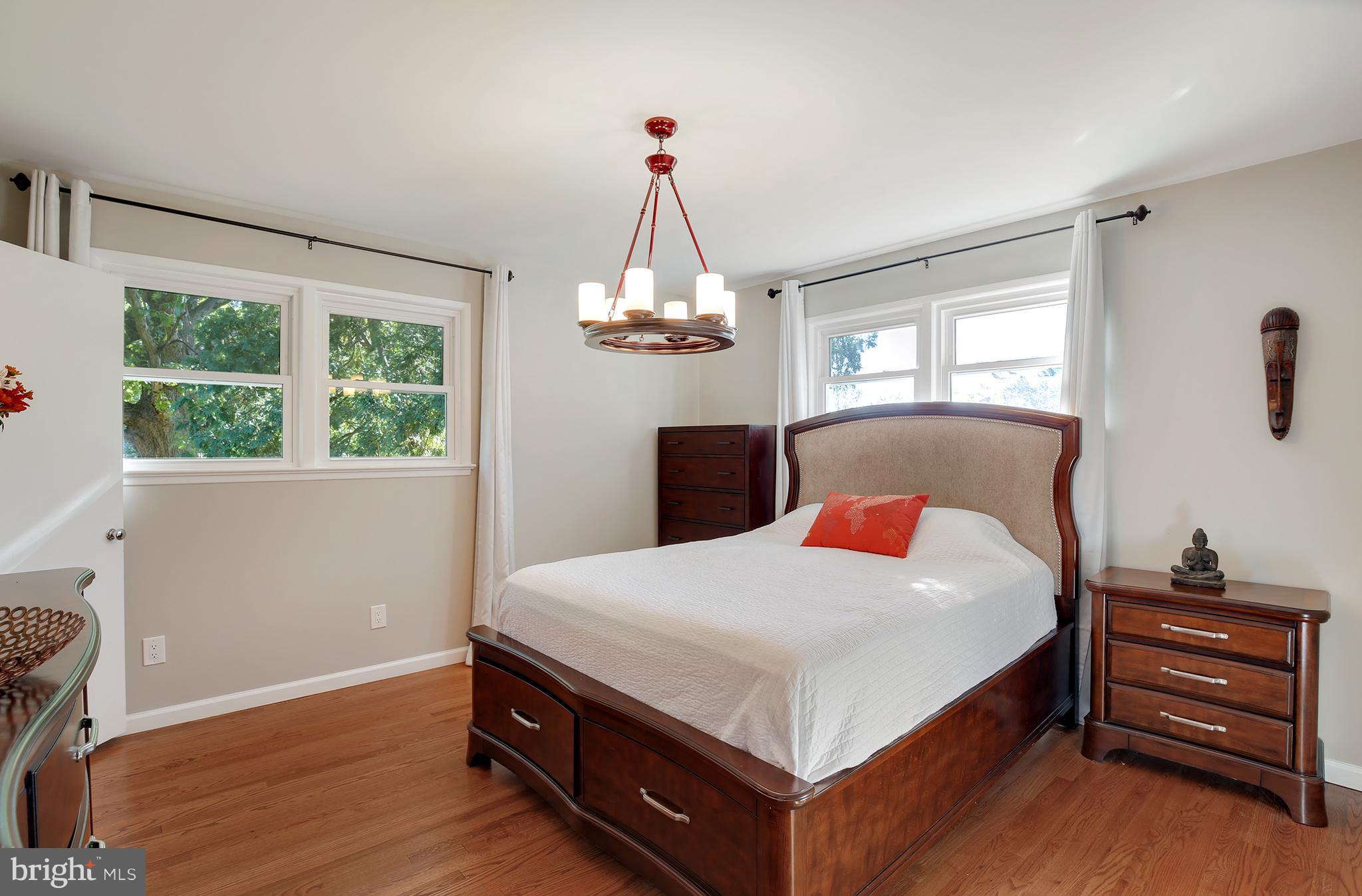 7422 Dunston Street Springfield, VA 22151 - Photo 20 of 30 a bedroom with a bed and wooden floor
