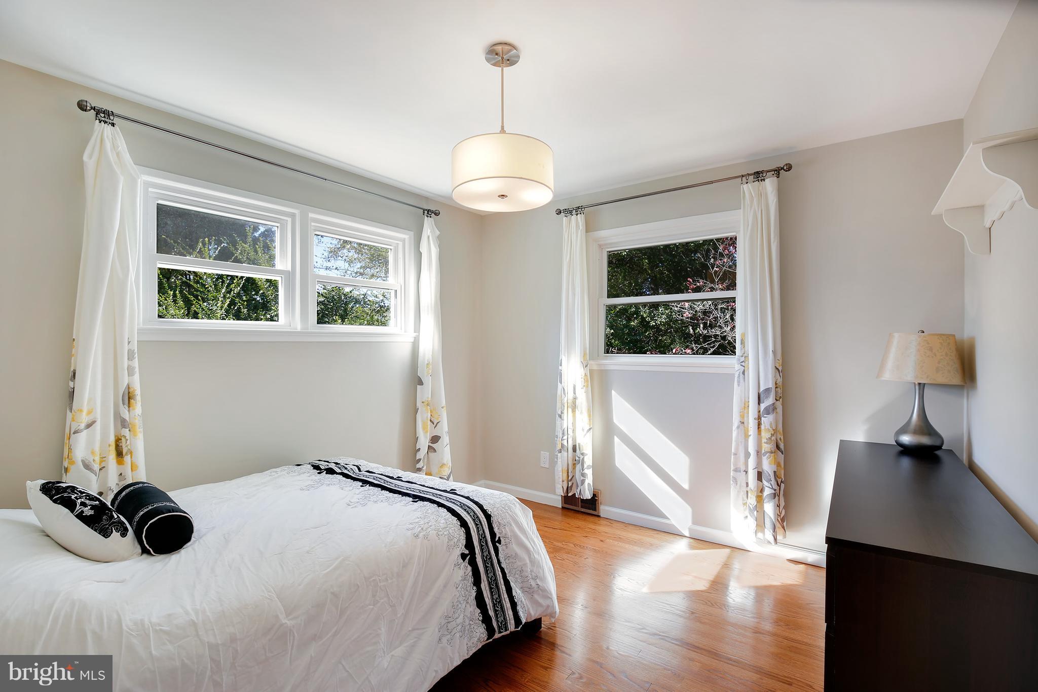 7422 Dunston Street Springfield, VA 22151 - Photo 21 of 30 a bedroom with bed and window