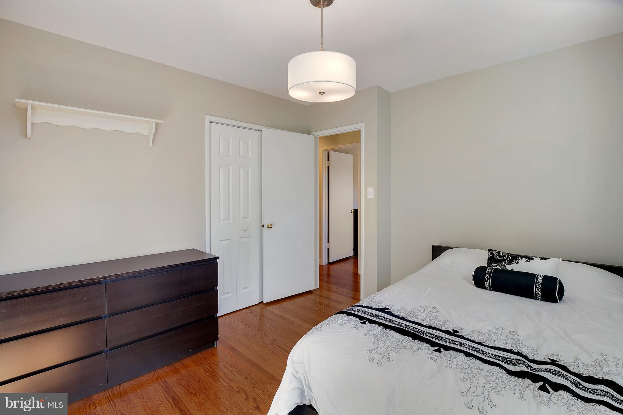 7422 Dunston Street Springfield, VA 22151 - Photo 22 of 30 a bedroom with a bed and a dresser