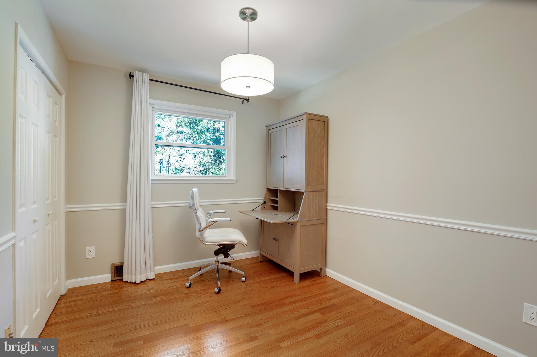 7422 Dunston Street Springfield, VA 22151 - Photo 23 of 30 a room with gym equipment and a window