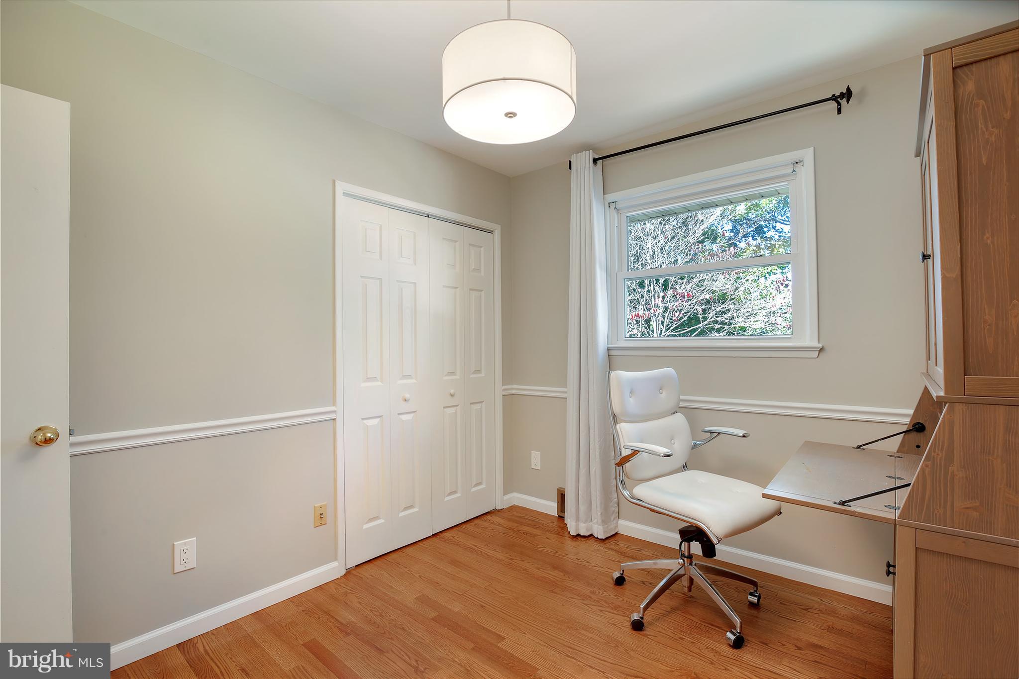 7422 Dunston Street Springfield, VA 22151 - Photo 24 of 30 a view of a room with wooden floor table and windows