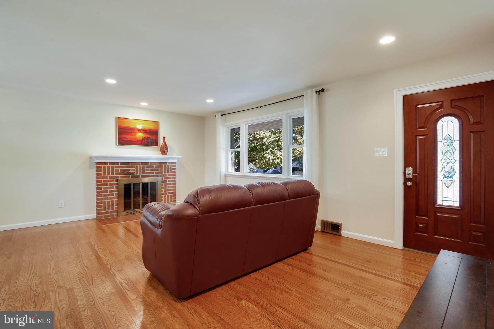 7422 Dunston Street Springfield, VA 22151 - Photo 5 of 30 a living room with furniture and a fireplace