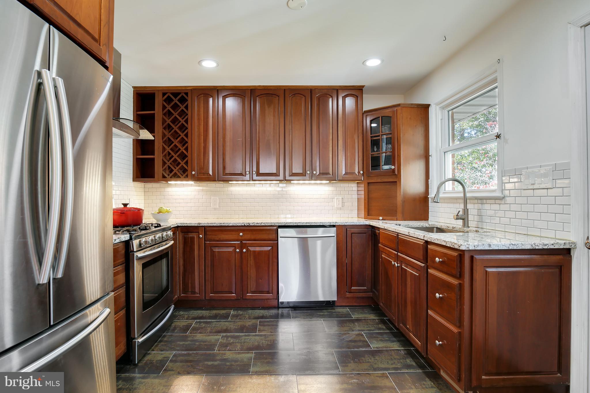 7422 Dunston Street Springfield, VA 22151 - Photo 10 of 30 a kitchen with stainless steel appliances granite countertop a refrigerator and a sink