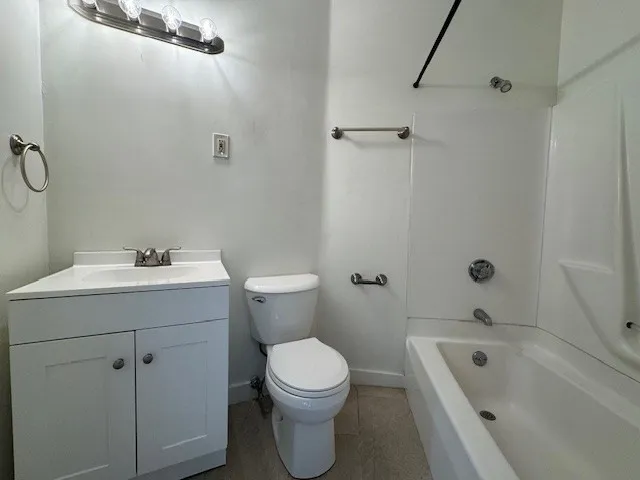 a view of a street with wooden wall