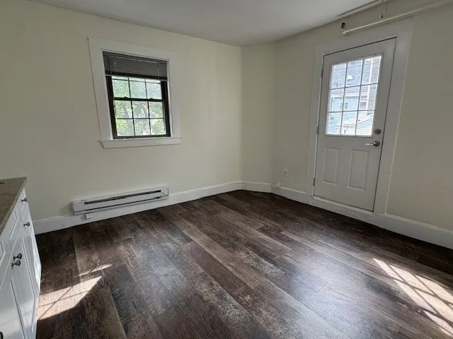 a big room with wooden floor and windows
