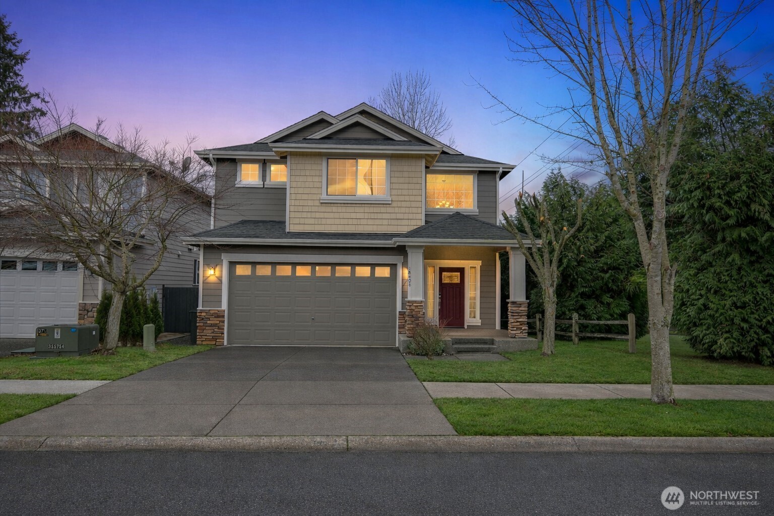 a front view of a house with a yard and garage
