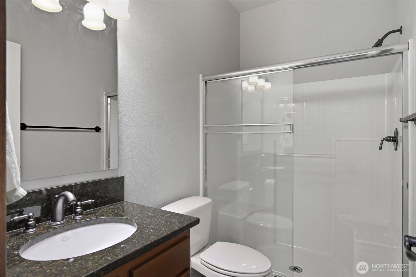 18408 41st Drive Southeast Bothell, WA 98012 - Photo 13 of 25 a bathroom with a sink toilet a mirror and shower