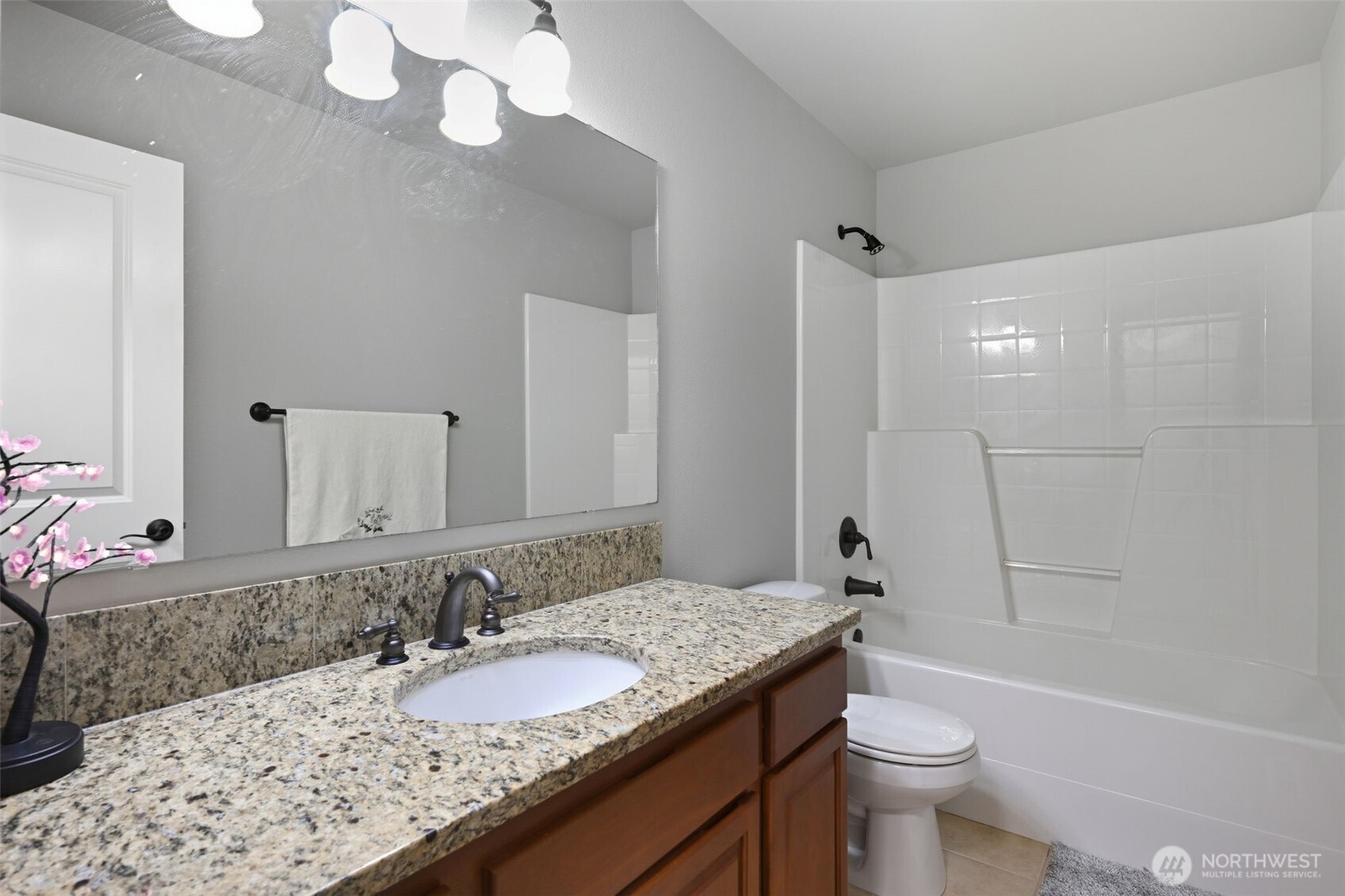18408 41st Drive Southeast Bothell, WA 98012 - Photo 22 of 25 a bathroom with a granite countertop sink a toilet and a mirror