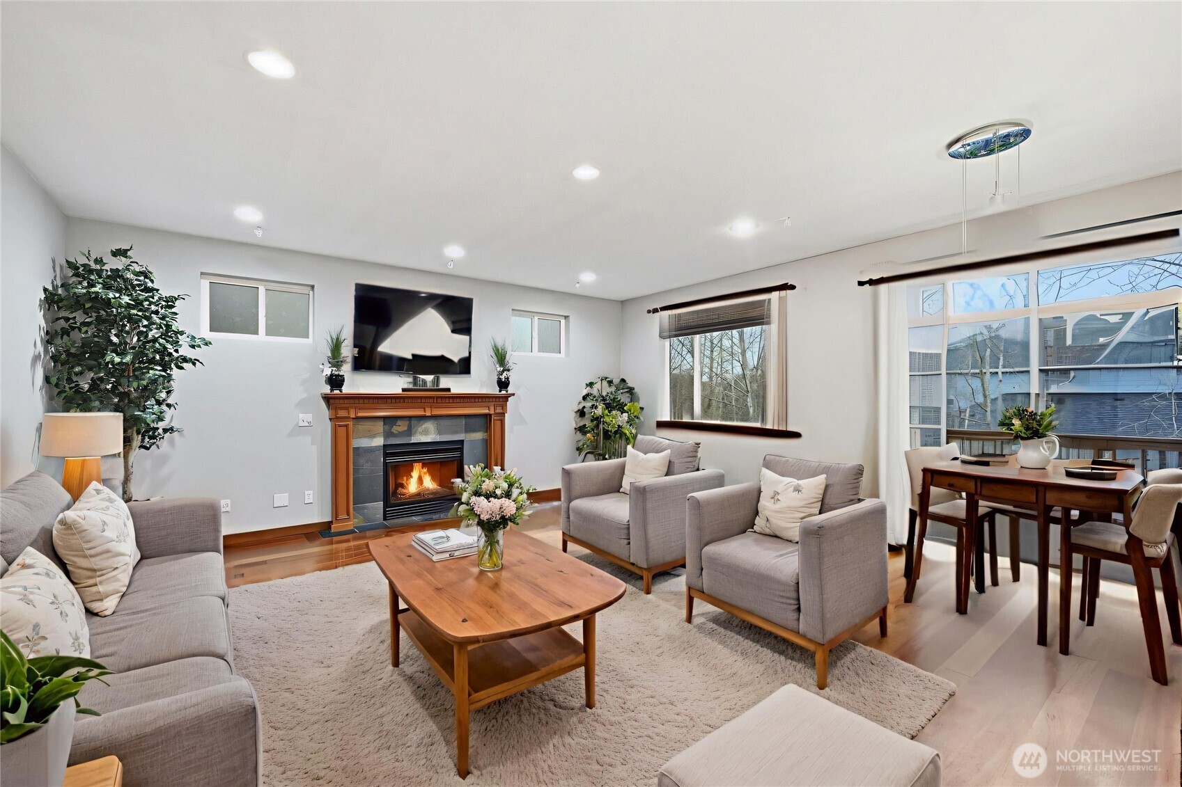 18408 41st Drive Southeast Bothell, WA 98012 - Photo 5 of 25 a living room with furniture a fireplace and a floor to ceiling window