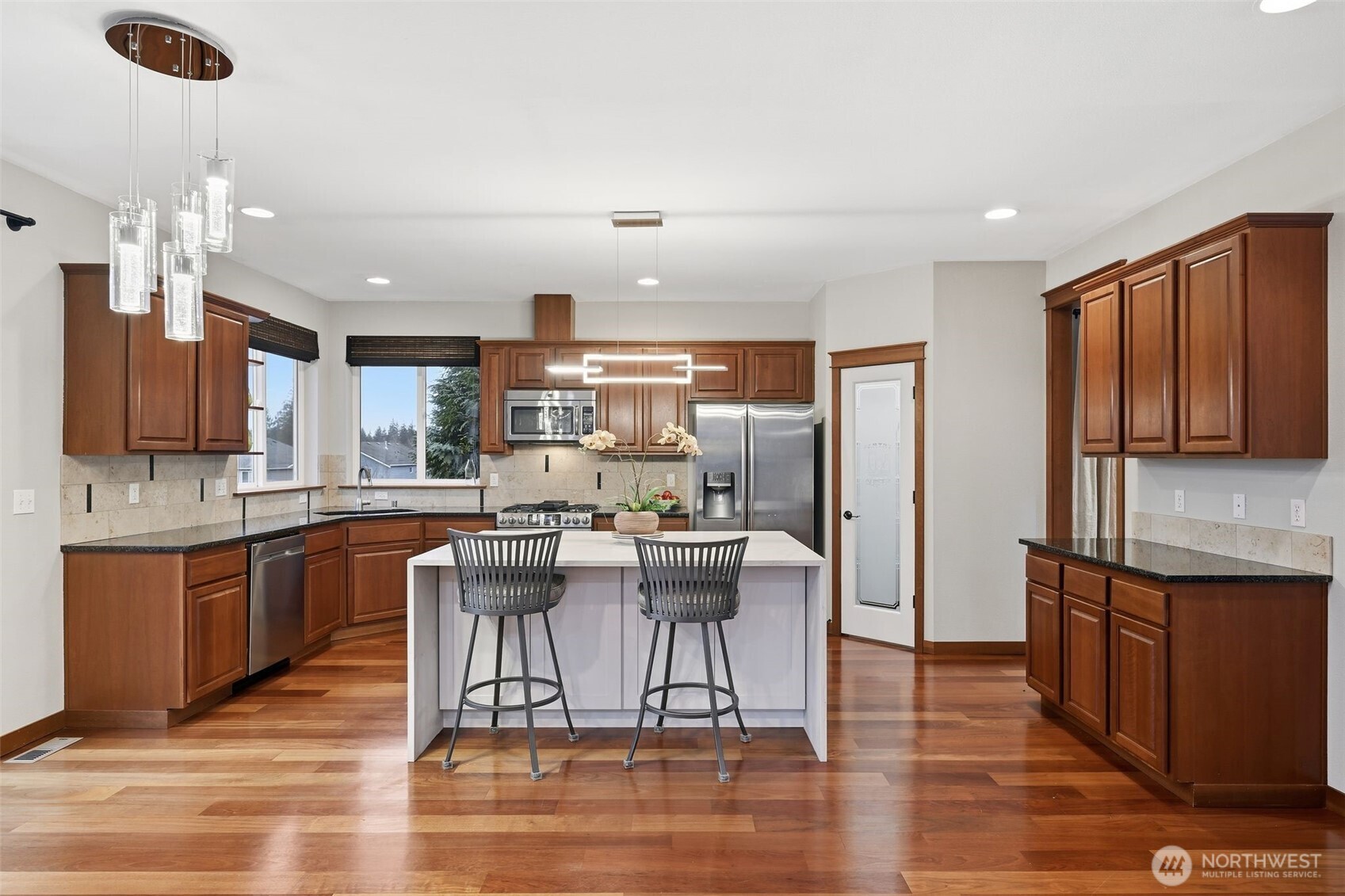 18408 41st Drive Southeast Bothell, WA 98012 - Photo 7 of 25 a kitchen with stainless steel appliances granite countertop a refrigerator a stove top oven and a center island