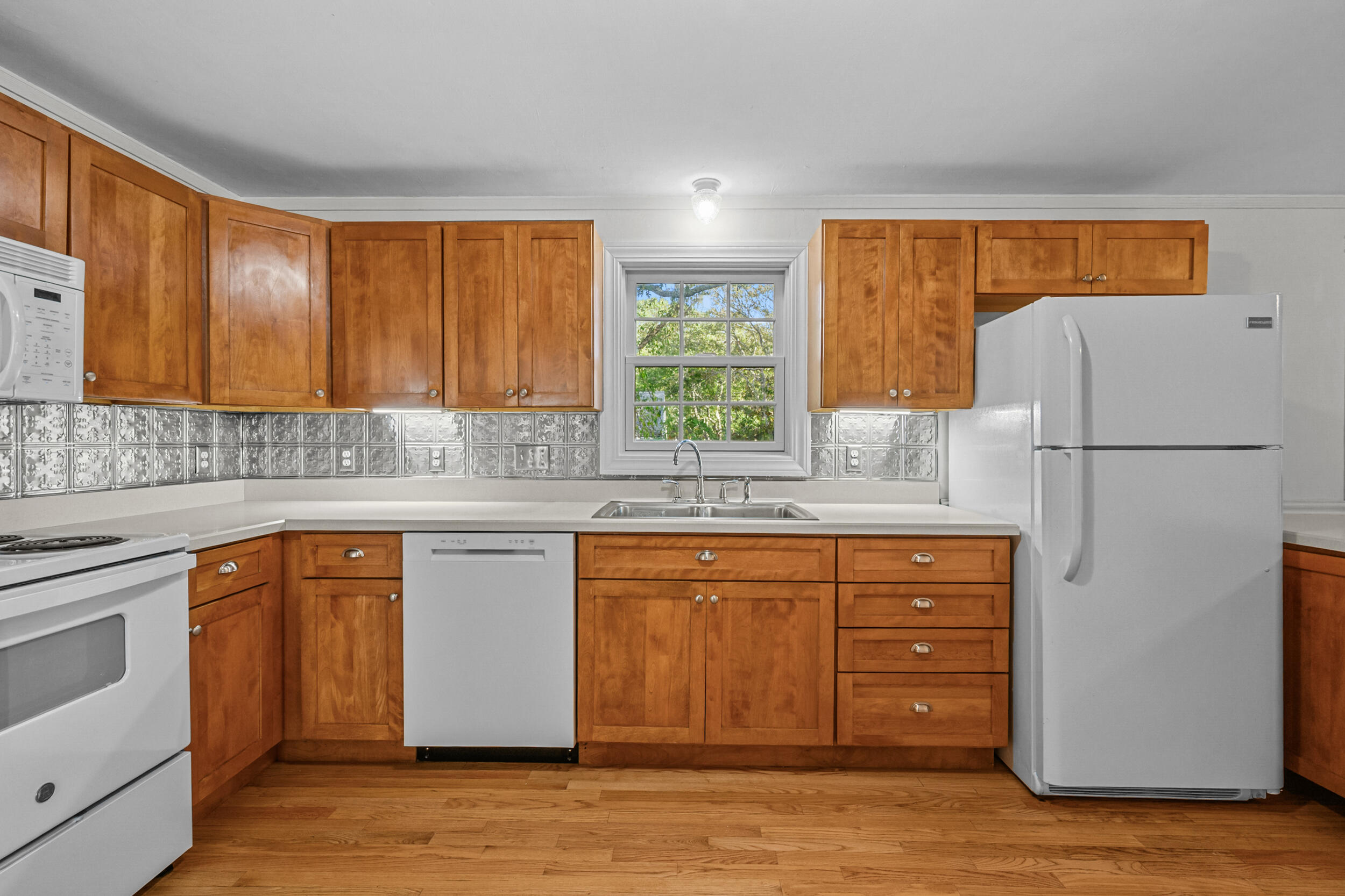 370 Compass Circle Hyannis, MA 02601 - Photo 11 of 26 a kitchen with stainless steel appliances granite countertop a refrigerator and a sink
