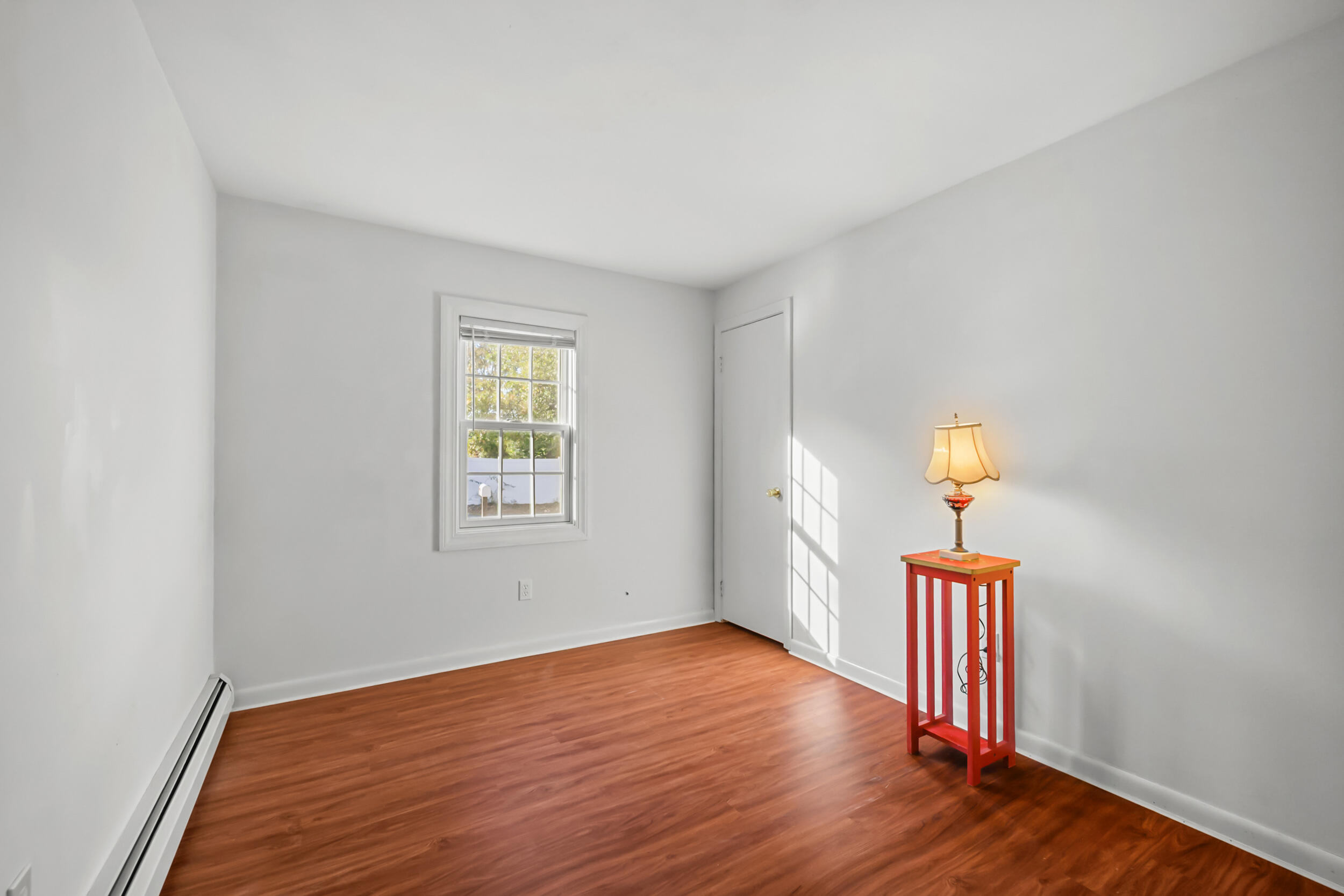 370 Compass Circle Hyannis, MA 02601 - Photo 13 of 26 a view of an empty room with wooden floor and a window