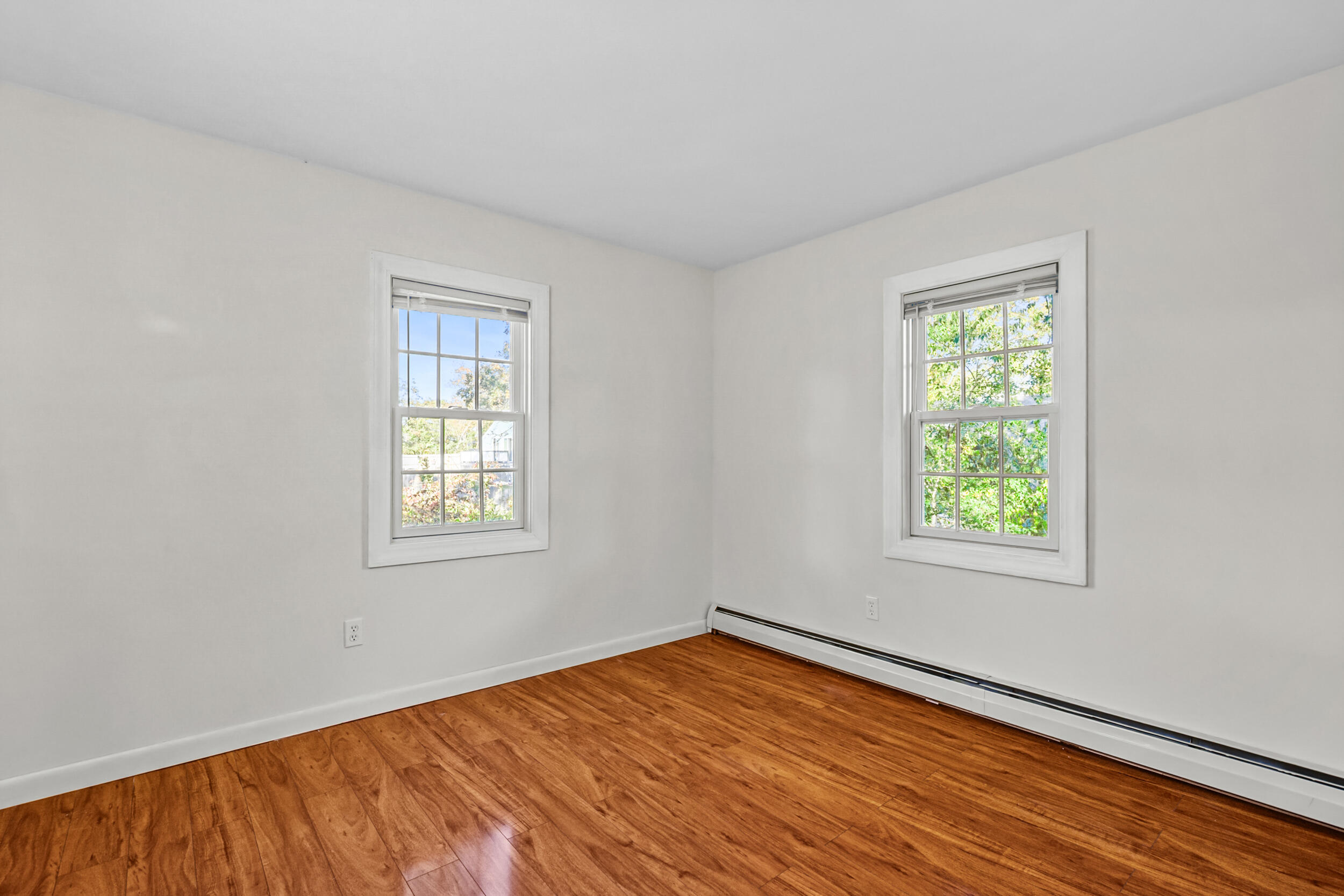 370 Compass Circle Hyannis, MA 02601 - Photo 14 of 26 a view of an empty room with wooden floor and a window