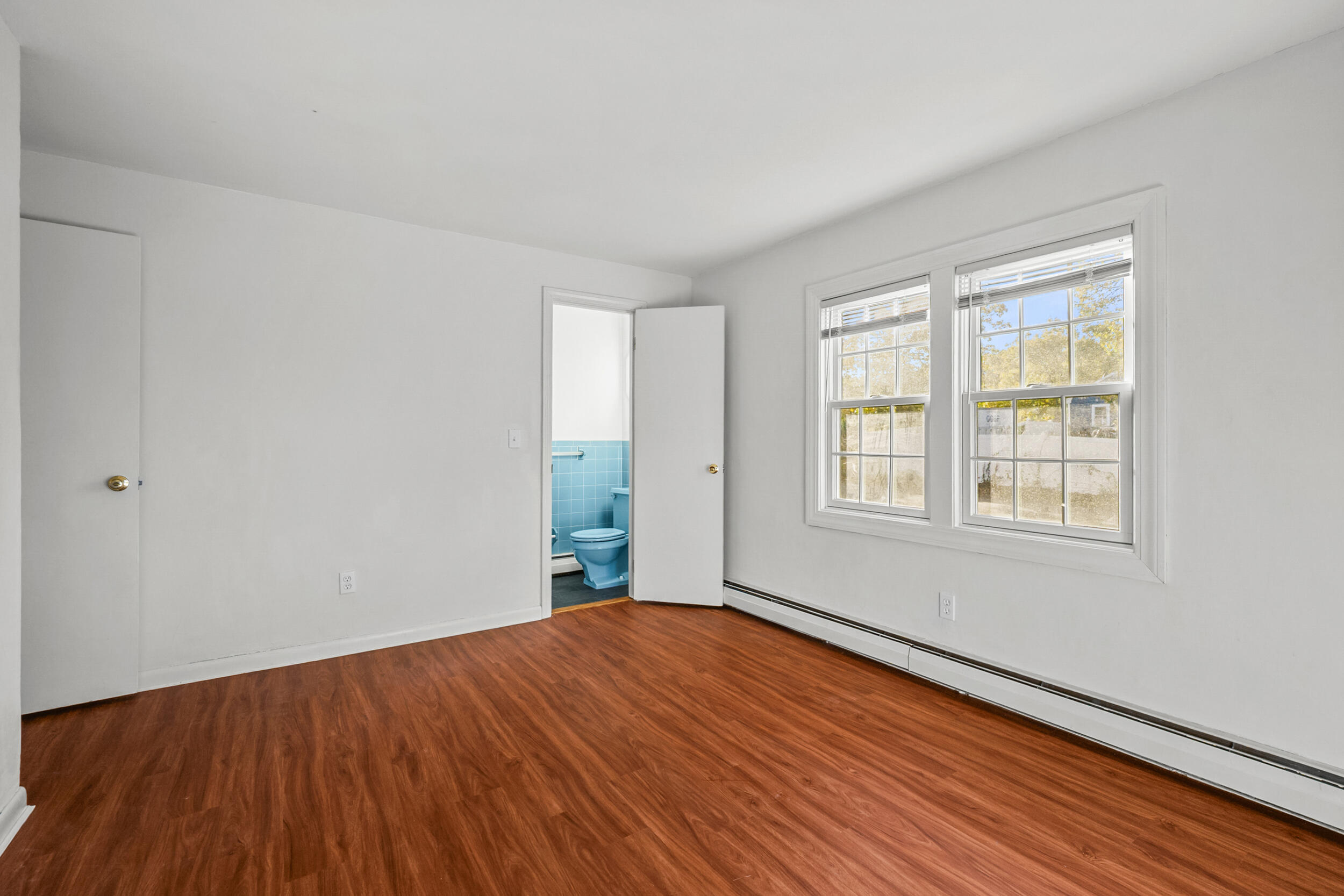 370 Compass Circle Hyannis, MA 02601 - Photo 18 of 26 a view of an empty room with wooden floor and a window