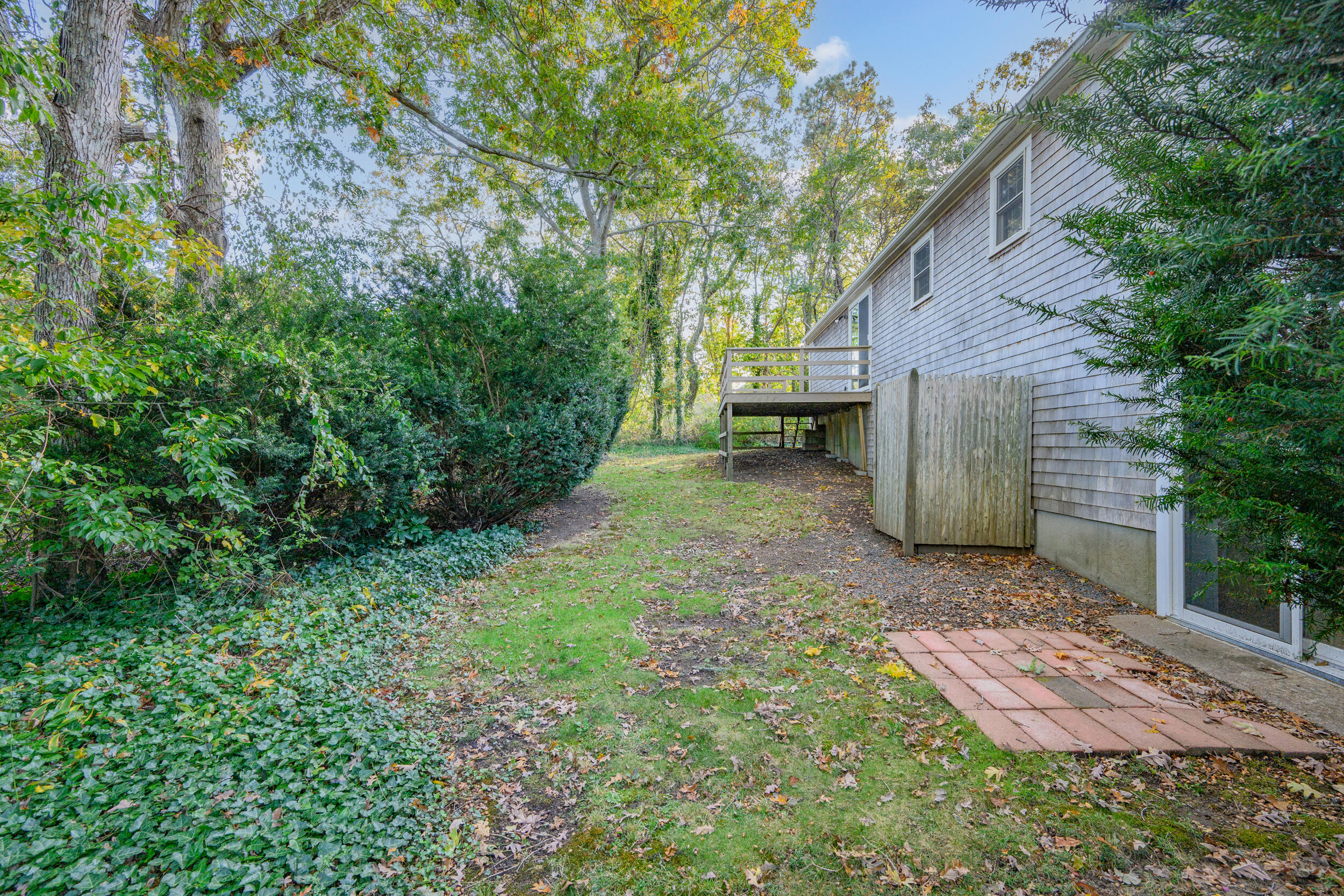 370 Compass Circle Hyannis, MA 02601 - Photo 25 of 26 a backyard of a house with lots of green space